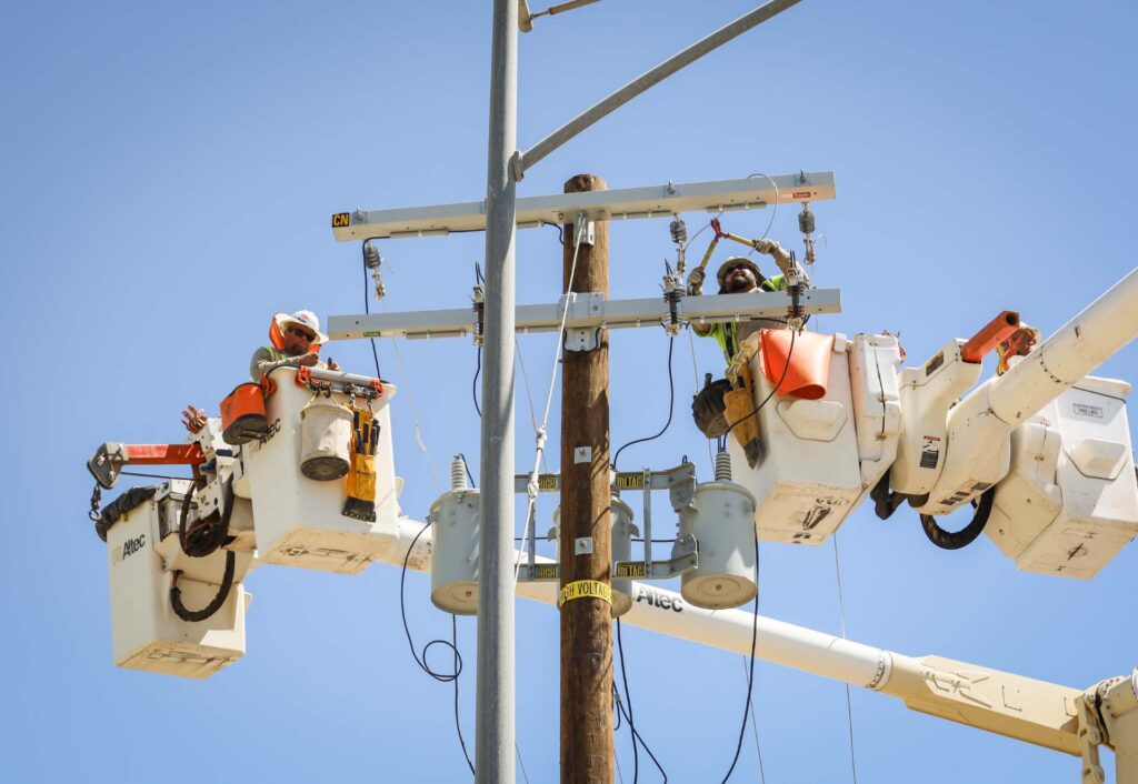 IID - linemen working IID - linemen working image